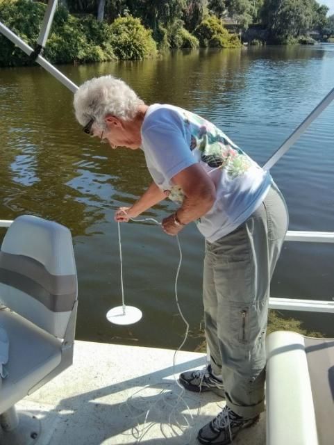 Figure 2. A Lakewatch volunteer in Lakeland, FL, demonstrates how to take a Secchi disk sample.
