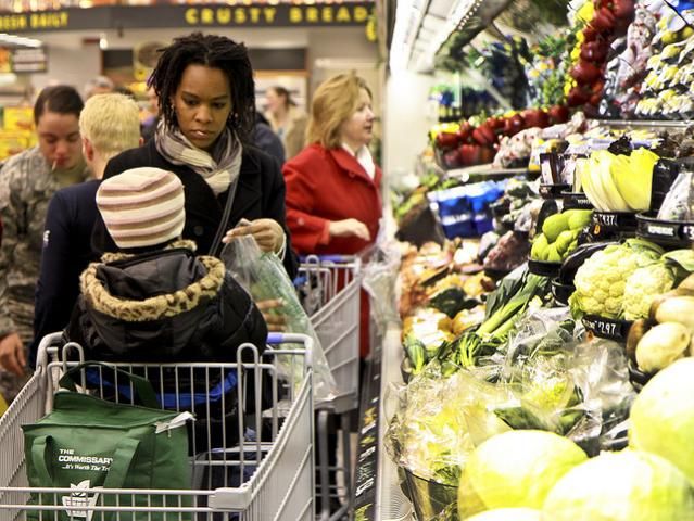 Figure 2. A mother listens to her son in the fresh produce aisle at the market.