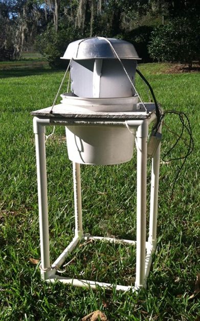 Black light trap for attracting and collecting click beetle adults at night. The electric light attracts adult click beetles, and a funnel below directs them into the bucket. 