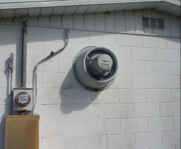 Figure 7. Exhaust fan at pesticide storage facility helps reduce temperatures and remove dust and vapors from the facility.