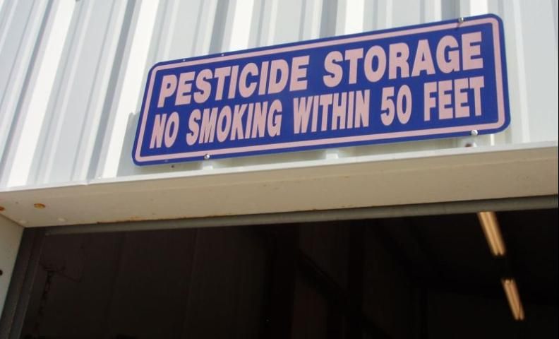 Figure 3. Post signs on storage facilities to alert people that pesticides are present.