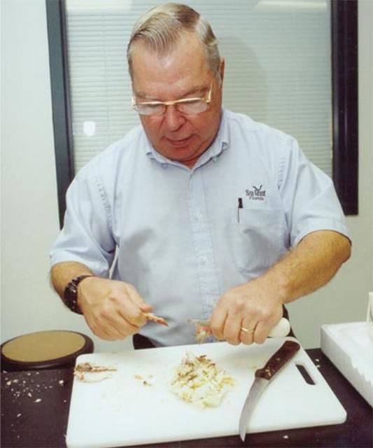 Donald E. Sweat, UF/IFAS Extension Marine Agent, demonstrates the preparation of blue crabs.