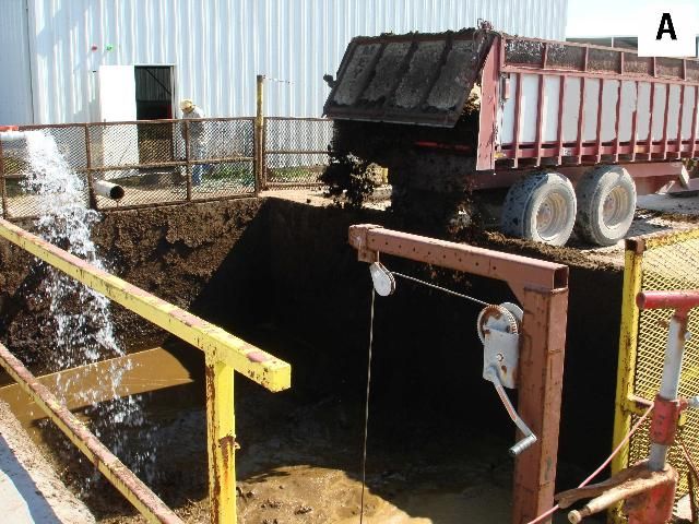 Figure 8. (A) Manure and bedding mixture is being loaded into (B) the mixed plug-flow anaerobic digester (biogas is unloaded at the far end).