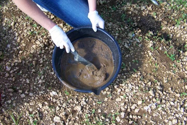 Figure 10. Mixing the sieved soil with water to make a slurry.
