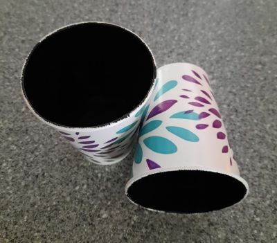 Image 23 2 cups painted black on the inside one upright, one on its side