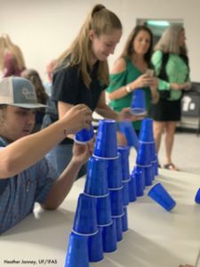 Youth at a 4-H Event practice stacking cups into pyramids.