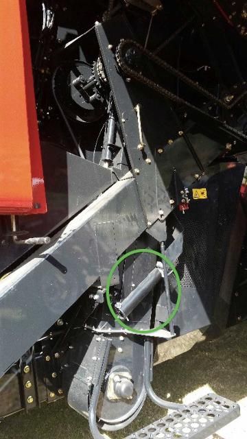 Figure 4. Moisture and temperature cylinder container (circled in green) on the side of the lower clean grain auger on a Case IH AF 6140.