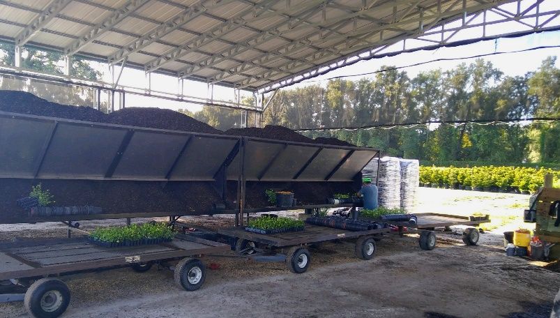 An example of a covered structure protecting potters, potting soils, and equipment over a potting area. 