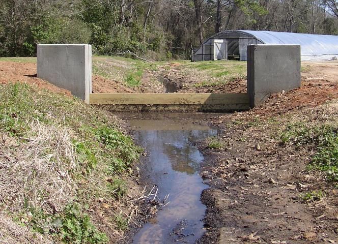 Figure 1. Wooden boards installed for management of runoff from watering station located upstream.