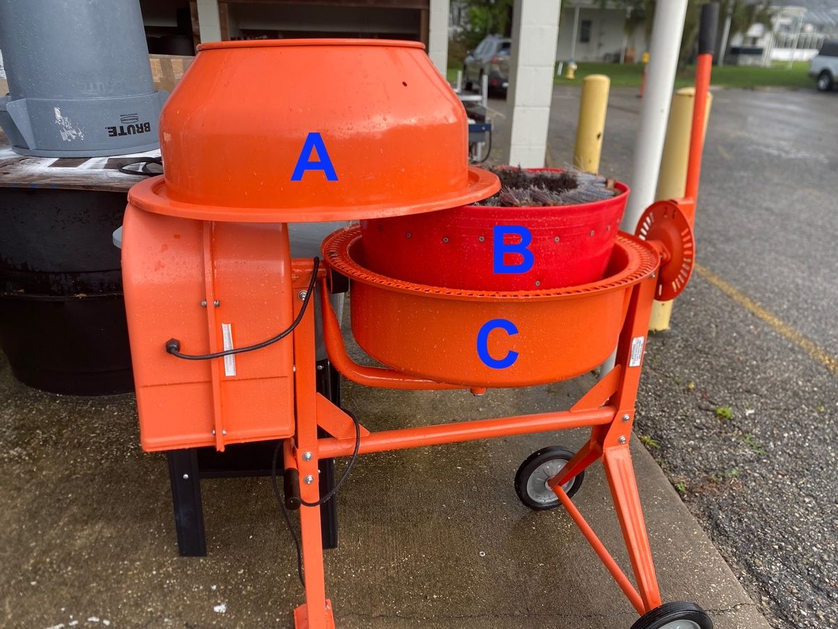 Cement mixer adapted into barrel washer by placing custom brush-lined tub inside mixer body under dome.