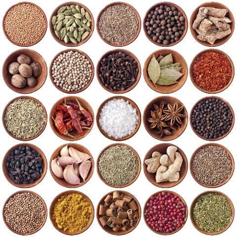 A collection of different spices in bowls

Description automatically generated