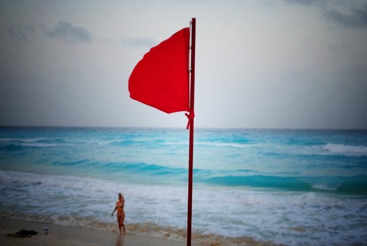 Figure 1. A red flag at the beach generally indicates hazardous conditions for water sports, but that still doesn't stop some people from going into the water anyway.
