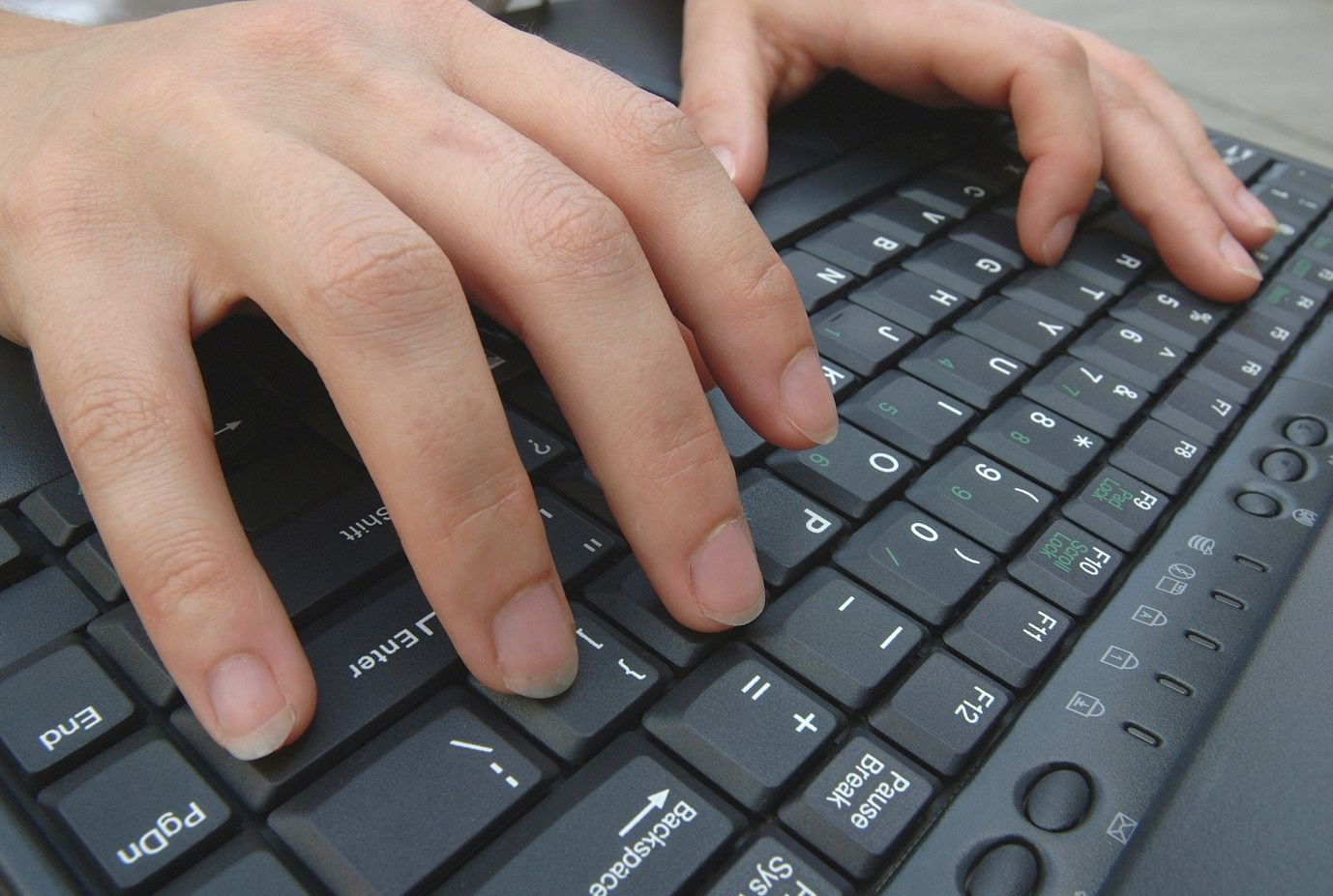Hands operating a keyboard. Some hackers surf the dark web seeking to acquire or purchase stolen identity information, so they can attempt to use it to break into the owner’s various financial accounts, start new accounts using the owner’s information, and have credit cards sent to an untraceable PO Box address. 