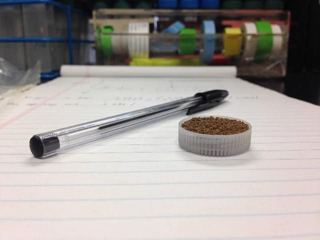 One full cap of soil. The volume of the cap is 0.8 tsp, and one cap dry soil is approximately 0.13 to 0.19 oz.