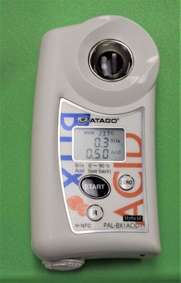 A portable titrimeter/refractometer for measuring soluble solids and acidity of juice.
