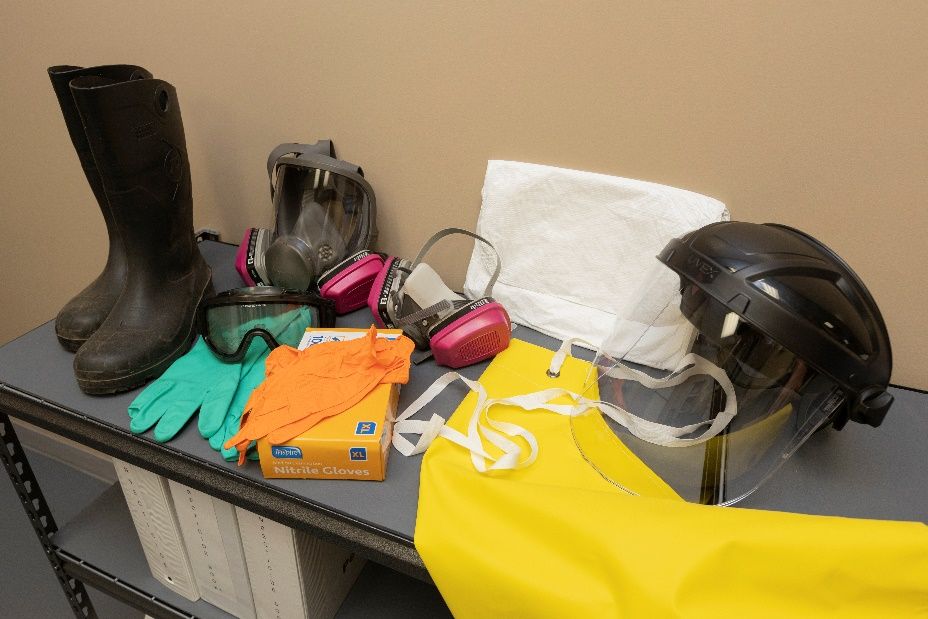 Various pieces of PPE equipment sitting on a shelf.