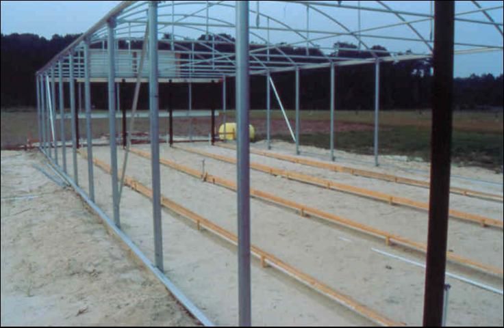 Figure 25. Installing greenhouse floor with leachate collection system.