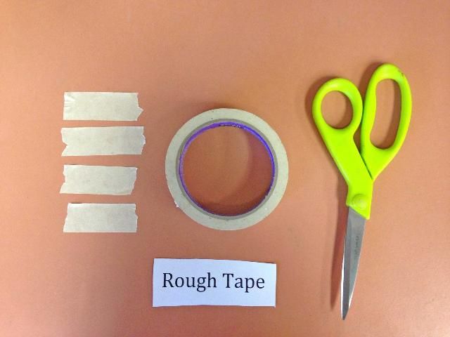 Figure 2. Four pieces of rough-surfaced tape cut to match the height of the wall of the small container.