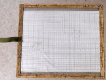 Figure 8. Sticky screens are used when a honey bee colony is equipped with a solid bottom board. The wooden frame with 1/8 inch mesh is placed on top of the sticky board to prevent honey bees from touching the sticky surface.