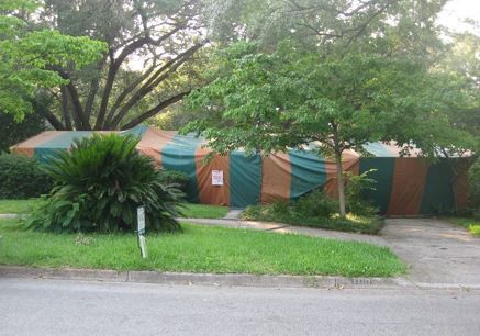 Figure 25. Fumigation is highly effective against drywood termites. Structures are tented and tightly sealed to hold the fumigant (active ingredient: sulfuryl fluoride). It is critical that no one enter the structure because he gas is highly toxic. Once properly aerated and cleared using sensitive instrumentation, the home can be entered again.