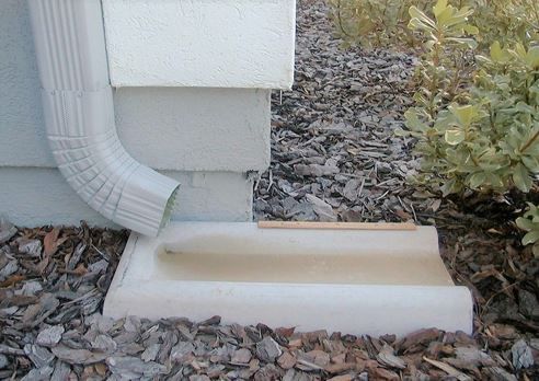 Figure 13. Splash block to divert water from gutter away from home.