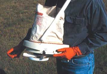 Hand-held bag spreader for fire ant treatment application.