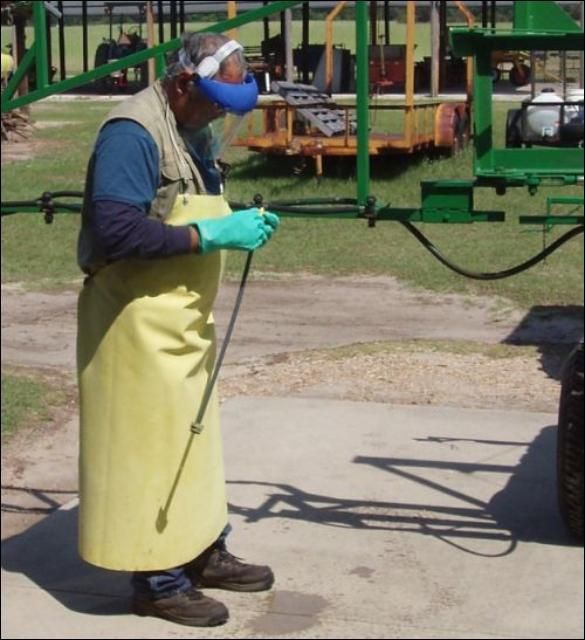 Figure 7. Some labels state that a chemical-resistant apron should be worn while cleaning application equipment.