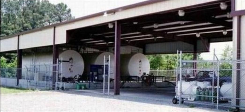 Figure 14. Large pesticide storage facility with bulk tanks within diking for containment and the area fenced for security.