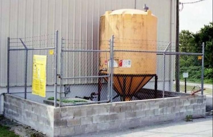Figure 4. Pesticide bulk storage tank contained within a cinderblock dike.