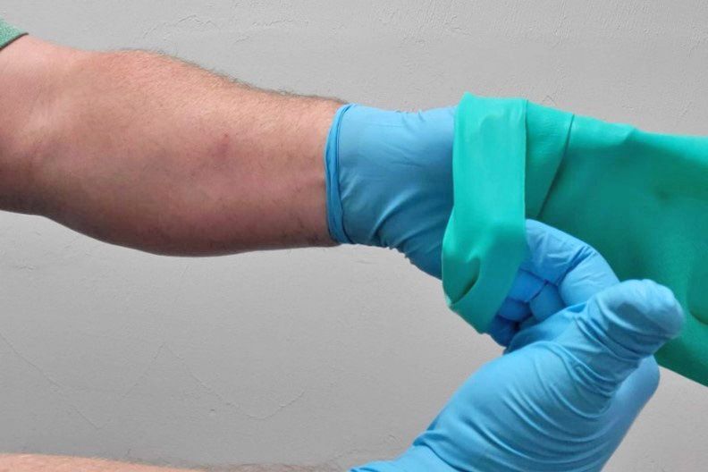 Double-gloving with exam gloves under chemical resistant gloves.