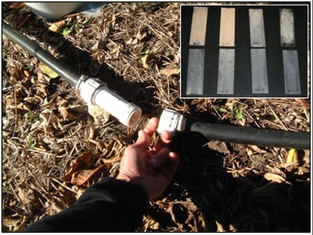 Figure 5. A 3/4-inch PVC coupling found in plumbing-supply stores serves well as in-line glass slide holder. Observing the amount, type, and rate of scale deposition occurring on a clean side (inset) can help determine the scaling potential of the irrigation water and the effect of injected scale-inhibiting chemicals.