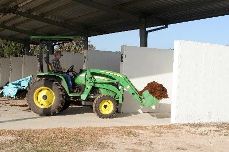 A tractor unloading or loading material. 